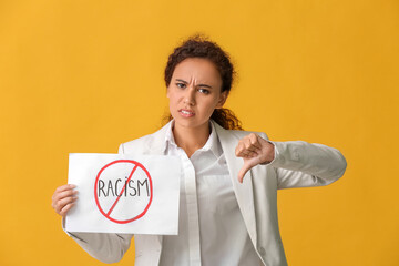 African-American woman with poster on color background. Stop racism