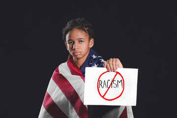 Sad African-American girl with poster and USA flag on dark background. Stop racism