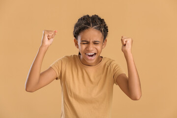 Stressed African-American girl on color background. Stop racism