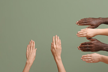 Hands of Caucasian women and African-American man on color background. Racism concept