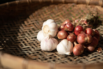 garlic and onions on a wooden table