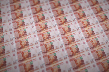 5000 russian rubles bills printed in illegal money production conveyor. Collage of many fake bills....