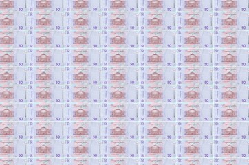 50 Ukrainian hryvnias bills printed in money production conveyor. Collage of many bills. Concept of...