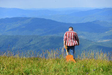 happy and free. cowboy man with muscular torso. acoustic guitar player. country music song. sexy man with guitar in checkered shirt. hipster fashion. western camping and hiking. copy space