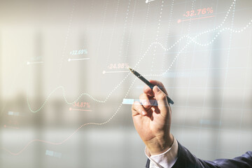 Double exposure of male hand with pen working with abstract creative statistics data hologram on blurred office background, analytics and forecasting concept