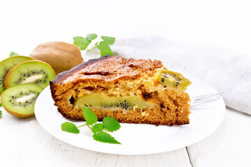 Pie with kiwi in plate on white board