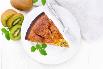 Pie with kiwi in plate on board top