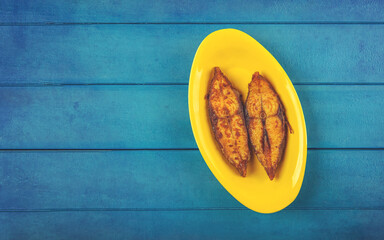 Home made spicy Fish fry on wooden table	
