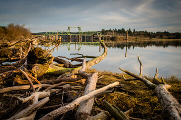 Bullards Bridge in Bandon, Oregon. Driftwood in foreground. 