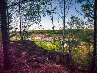 Granite stone quarry among the forest. Beautiful stones and rocky cliffs.