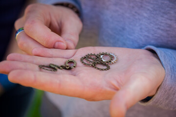 The pendants and chains were lying in the hand of a woman.