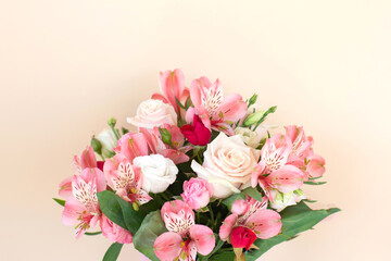 Beautiful bouquet of rose and alstroemeria flowers on light background.