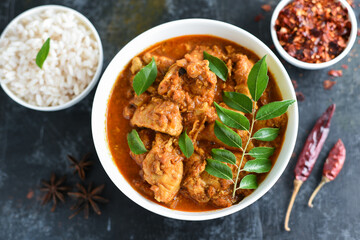 Kerala style chicken curry and rice, with gravy,  a hot and spicy dish in Kerala India. Traditional Indian side dish masala chicken served with Roti, Chapati, rice, naan, Paratha or Parantha.