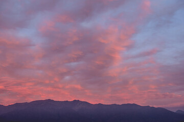 Panorama of amazing purple cloudy sunset sky over Los Andes mountains
