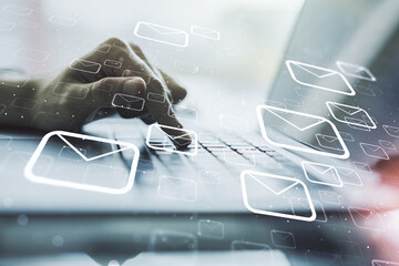 Creative concept of postal envelopes illustration with hands typing on laptop on background. Email...