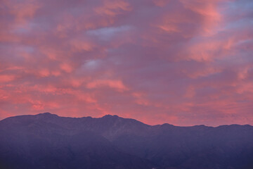 Panorama of amazing purple cloudy sunset sky over Los Andes mountains