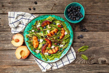 Fruit and berry mix Salad. Vegetarian appetizer grilled peaches salad with caramelized peaches, blueberry and goat cheese, catering, banner menu