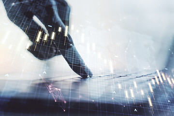 Double exposure of abstract creative financial chart with world map and with hands typing on computer keyboard on background, research and strategy concept