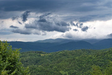 Fototapeta na wymiar Stormy clouds over the hills