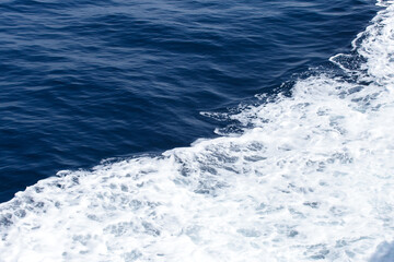 Blue Seawater with sea foam as background