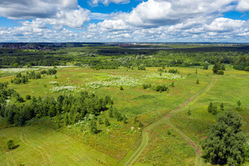 Fototapeta na wymiar Aerial view of a country road through fields and woods