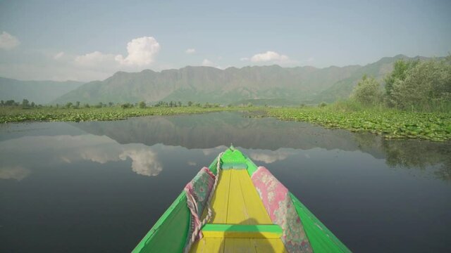 Shikara Boat Cruising At The Dal Lake With Mountain View And Blue Sky In Kashmir, India. - POV - wide shot