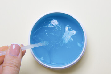 Skin care concept, anti-aging moisturizing eye mask, hydrogel patches in woman hands , top view