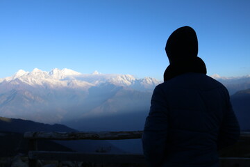 silhouette of a man standing watching a mountain nepal