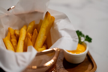 French fries in basket with mustard sauce