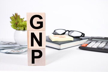 GNP Gross National Product sign on colorful wooden cubes, business concept.