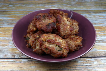 Deep fried marinated pork with soy sauce and pepper on the plate. Roasted chopped pork seasoning with spices and herbs. Famous party menu in Asia. 