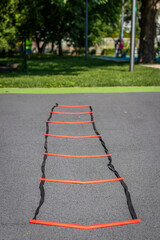 Coordination ladder on a sports background.