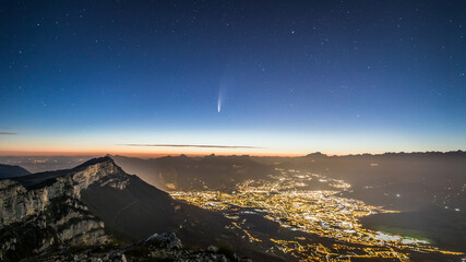 Neowise comet over grenoble and silouhette of mountain range