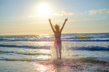 Fototapeta na wymiar Happy woman in waving sea
