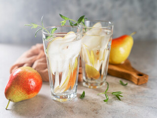 Cool summer drinks, pear cocktails with ice in glasses.