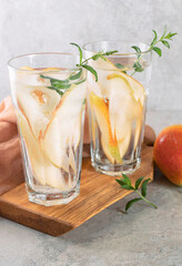 Cool summer drinks, pear cocktails with ice in glasses.
