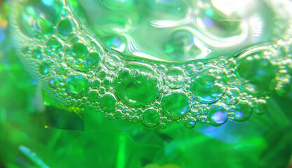   foam bubbles on the surface of green liquid close-up , selective focus      
