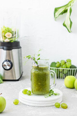 Green vitamin smoothie with shoots of young peas. Green smoothie made from apple, grape and kiwi
