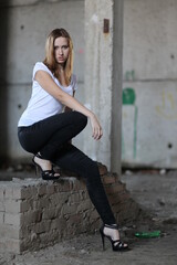 Beautiful young girl in the concrete building at night