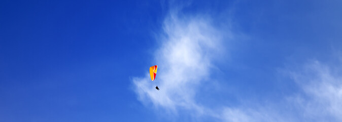 Skydivers in blue sky at sun day