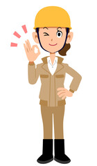 OKのサインを出すヘルメットを被った作業着の女性
