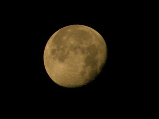 Waning moon in dark night sky