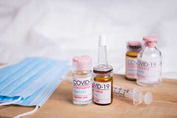 Bottle of coronavirus vaccine on table.
 Coronavirus vaccine COVID-19.