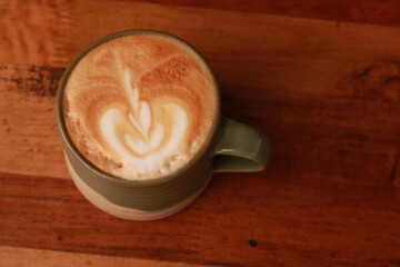 coffe latte cup on a wood table.