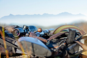 Hunting rifle. still life with mountains background.