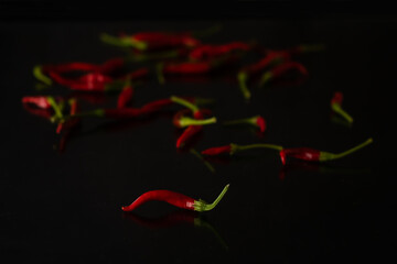 Red hot chilly pepper on black table top