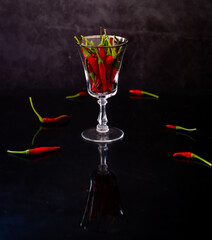 Red hot chili pepper in old wine glass
