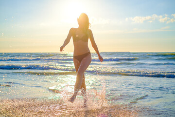 Happy woman in waving sea