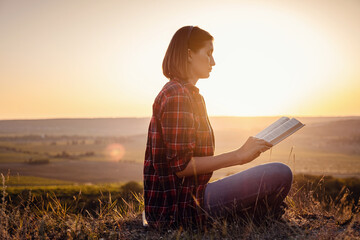 beautiful woman writing into her diary, in the park