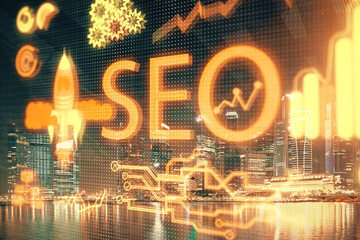 SEO hologram on city view with skyscrapers background double exposure. Search optimization concept.